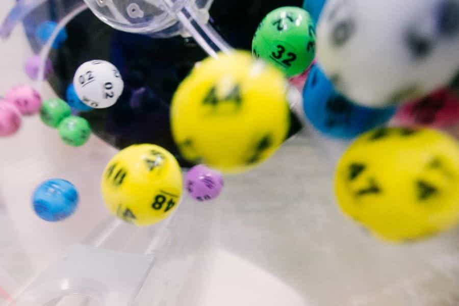 Colorful lottery balls bouncing around inside a spinner.
